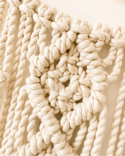 Detailed view of Egyptian cotton macrame knots on crescent moon wall decor