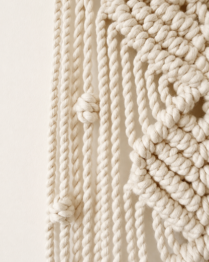 Detailed side view of handmade knots and cords on macrame moon wall hanging