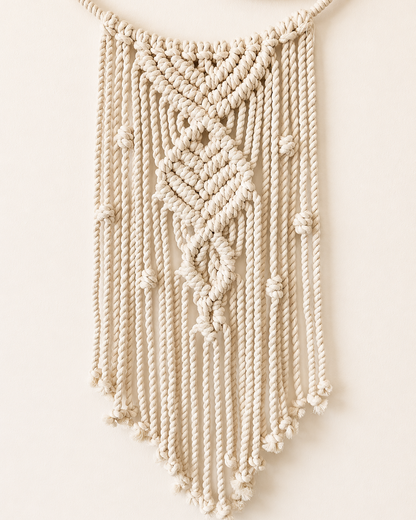Handmade macrame crescent moon wall hanging with textured central knot design