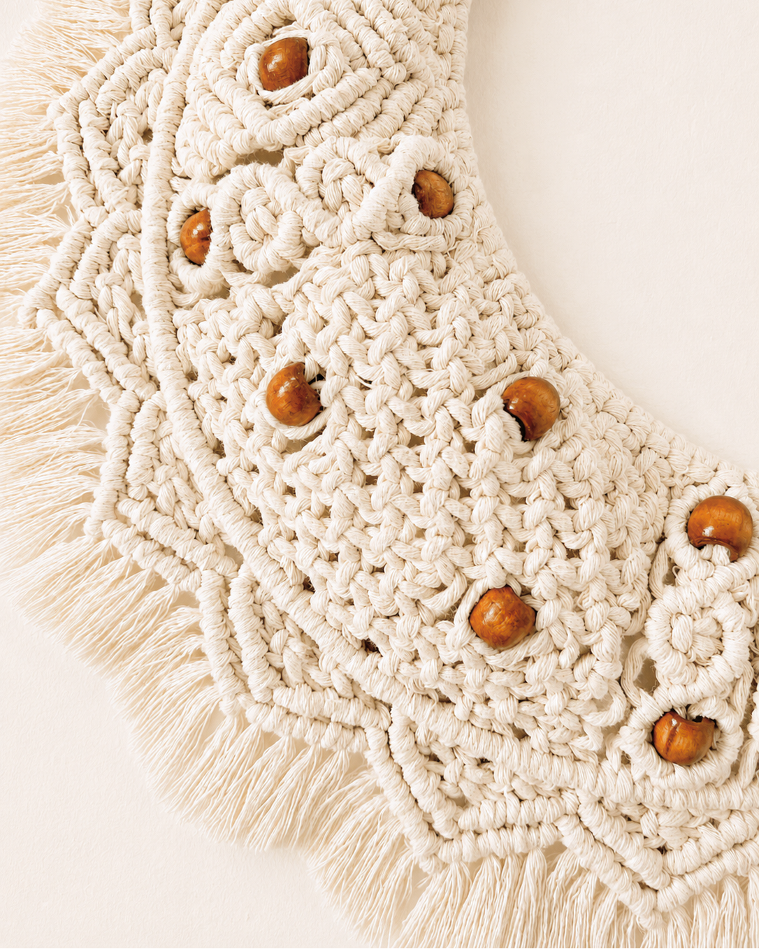 Detailed macrame crescent moon wall decor with brown wooden beads and off-white cotton knots