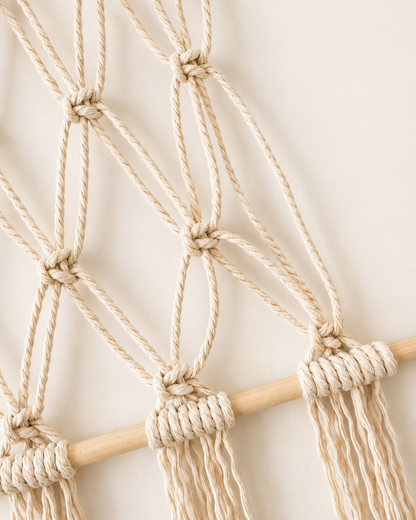 Close-up of handmade macrame photo holder knots and natural cotton cord