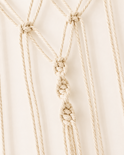 Close-up of decorative centre knots on handmade macrame photo holder