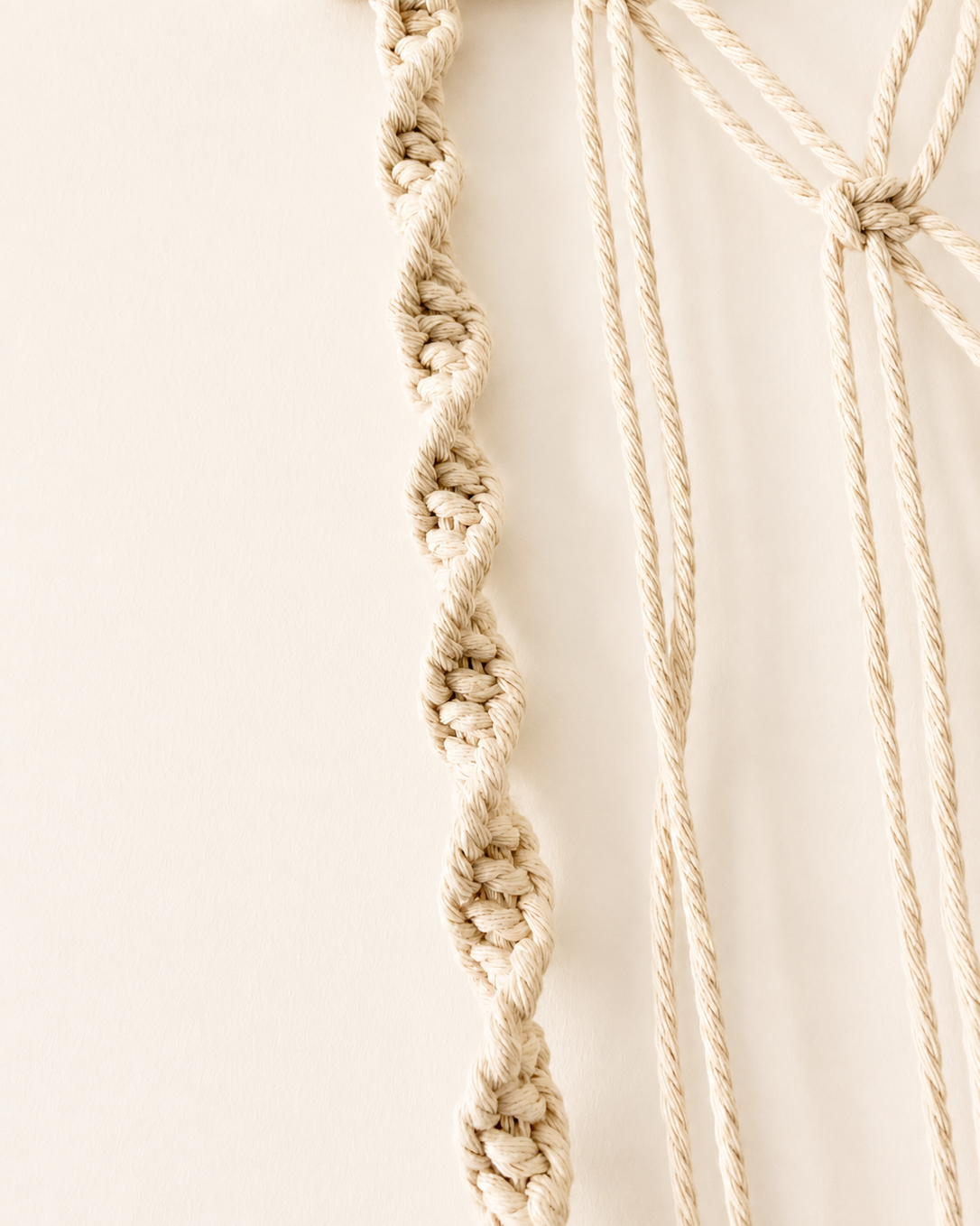 Close-up of decorative spiral knot detailing on macrame photo holder