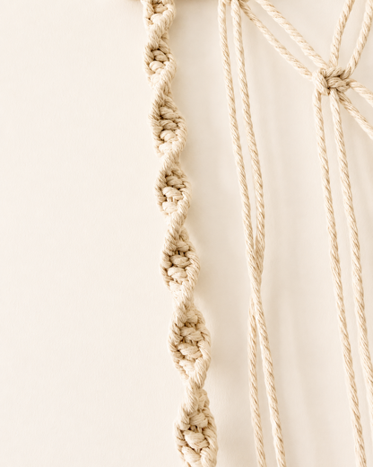 Close-up of decorative spiral knot detailing on macrame photo holder