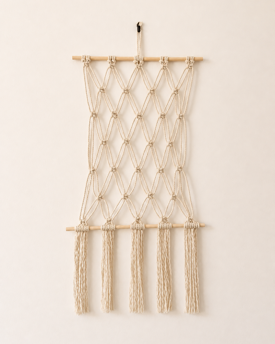 Handmade macrame photo holder wall display with wooden dowels and long fringe