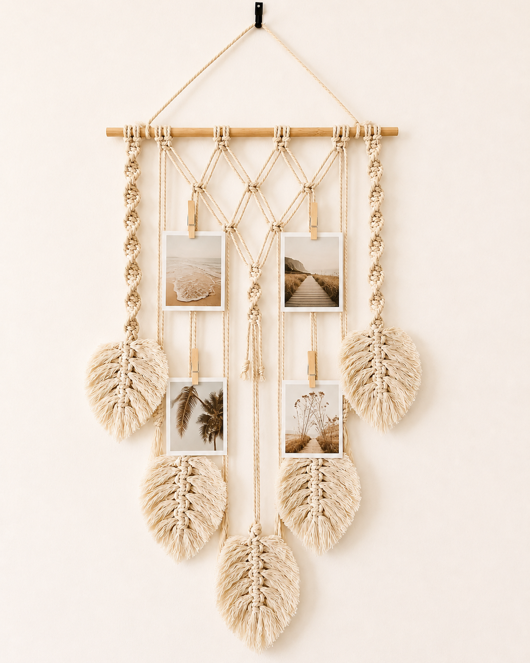 Handmade macrame photo holder with five leaves and wooden pegs displaying photos