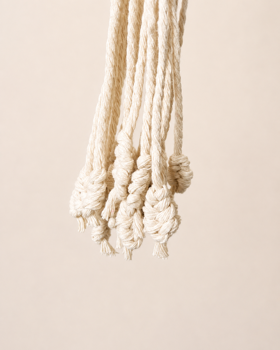 Decorative knotted tassel detail on cotton macrame plant hanger