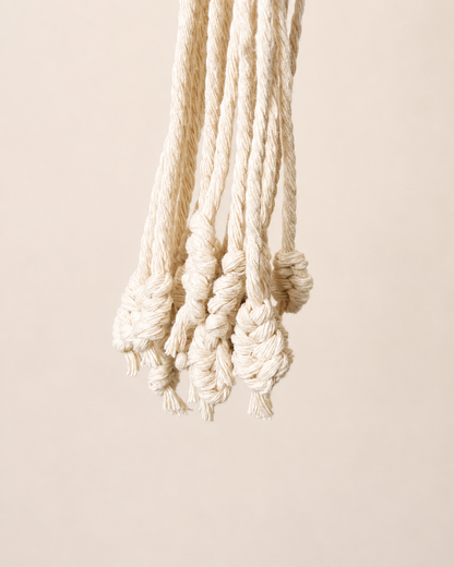 Decorative knotted tassel detail on cotton macrame plant hanger