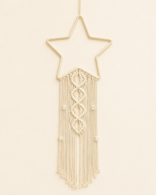 Macrame star wall hanging handmade with cotton cord and decorative fringe in off white boho nursery decor style