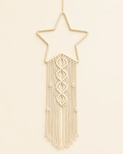 Handmade macrame star wall hanging with intricate knotwork and cotton fringe.