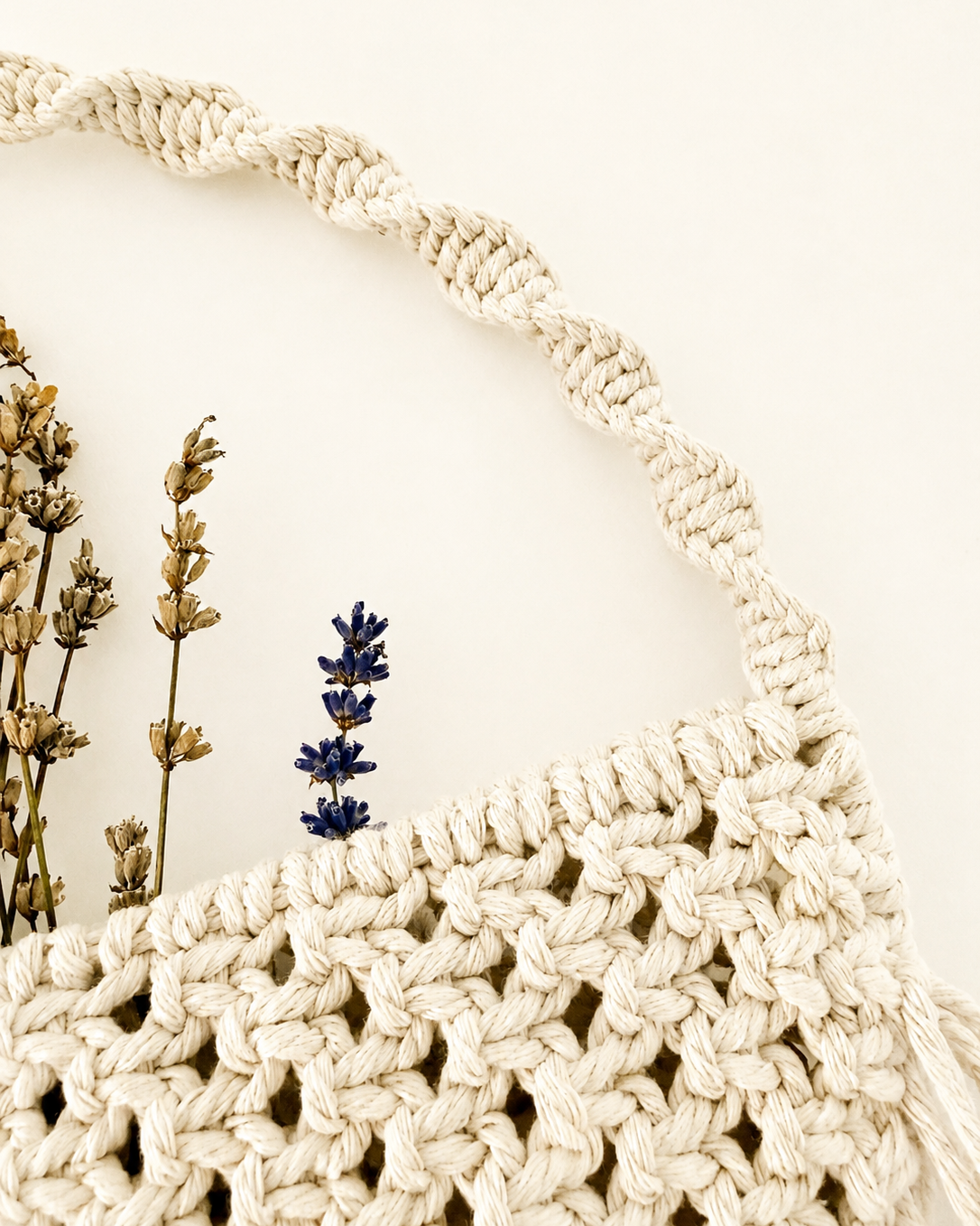 Braided hanging handle on a handmade Egyptian cotton macrame wall pocket.