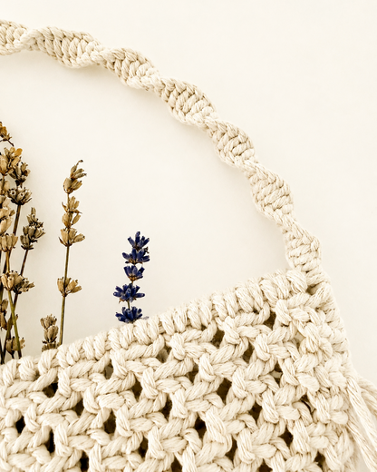 Braided hanging handle on a handmade Egyptian cotton macrame wall pocket.