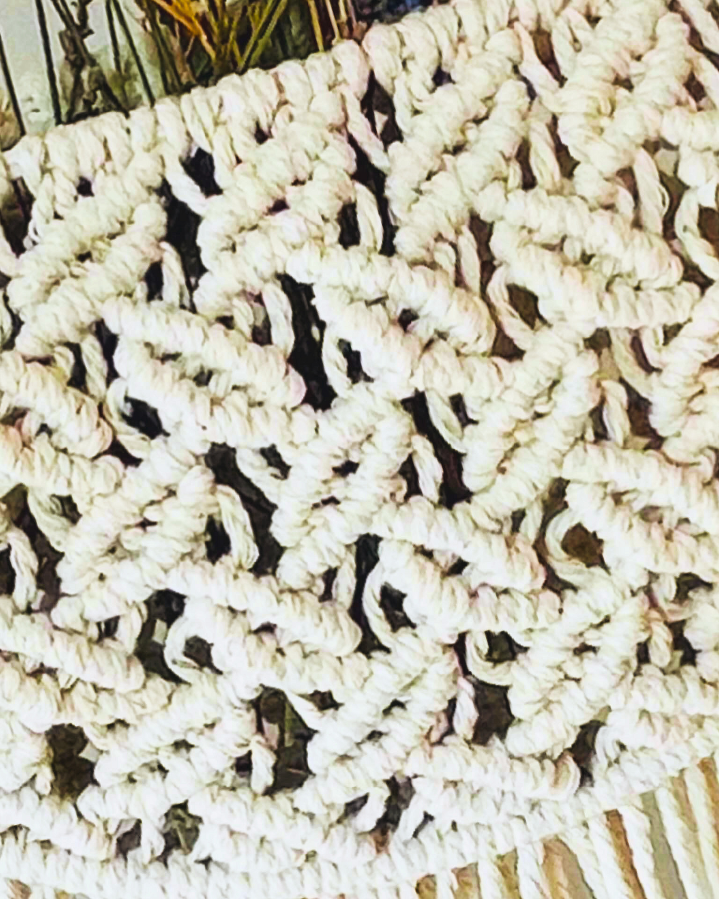 Close-up of the intricate knot pattern on a handmade Egyptian cotton macrame wall pocket.