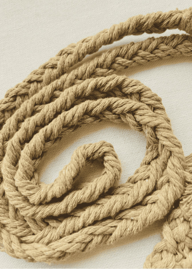 Close-up of the light brown cotton macramé strap showing intricate braided design and soft fibre texture.
