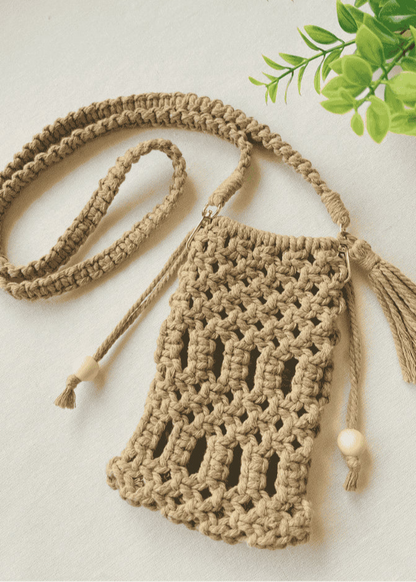 Full handmade macramé crossbody phone bag in light brown with boho-style strap and tassels