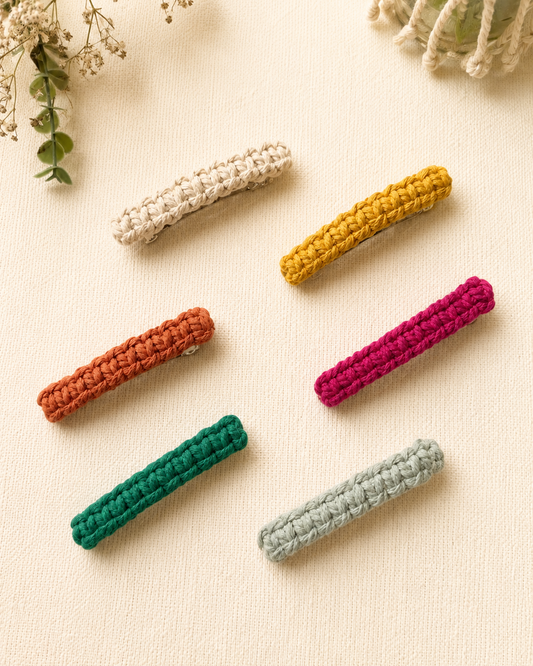 Handmade macramé hair clips crafted with cotton cord in terracotta, mustard, green and pastel colours.