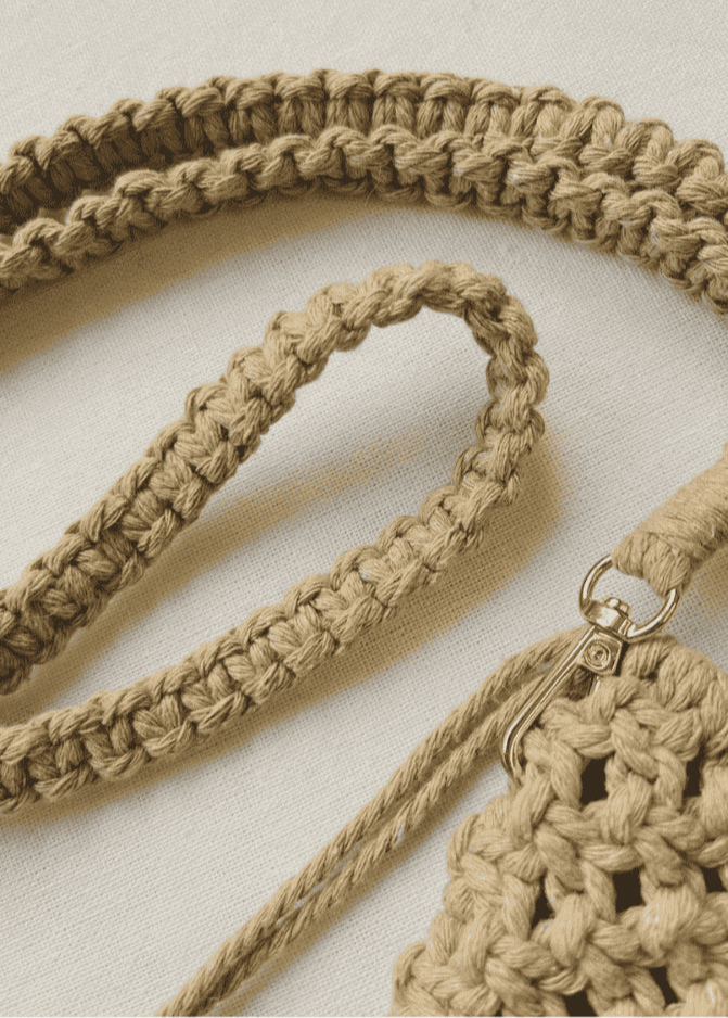 Braided cotton strap and gold clasp detail of macramé phone bag in light brown cord