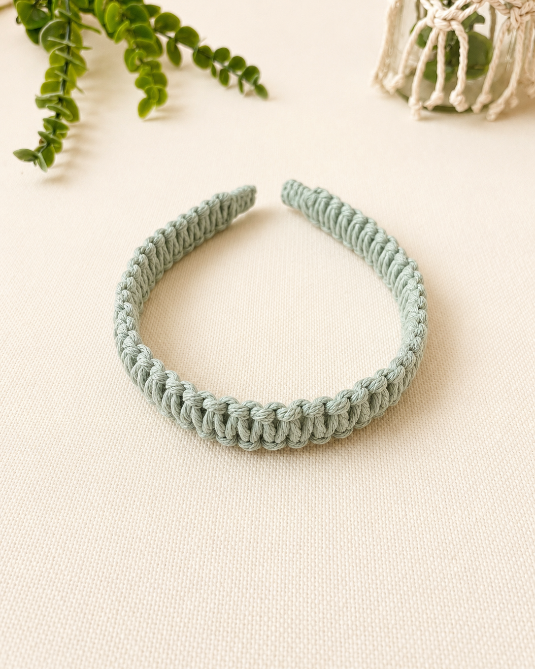 Handmade mint green macrame square knot headband made from cotton cord.