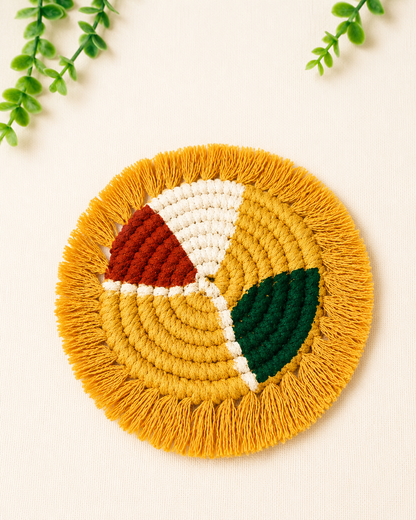 Handmade mustard geometric macramé coaster with fringe edges in mustard, off white, terracotta and green cotton cord.