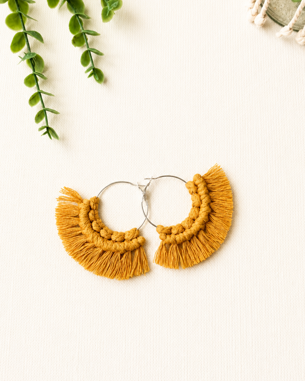 Handmade mustard yellow macrame fringe hoop earrings with stainless steel hoops.