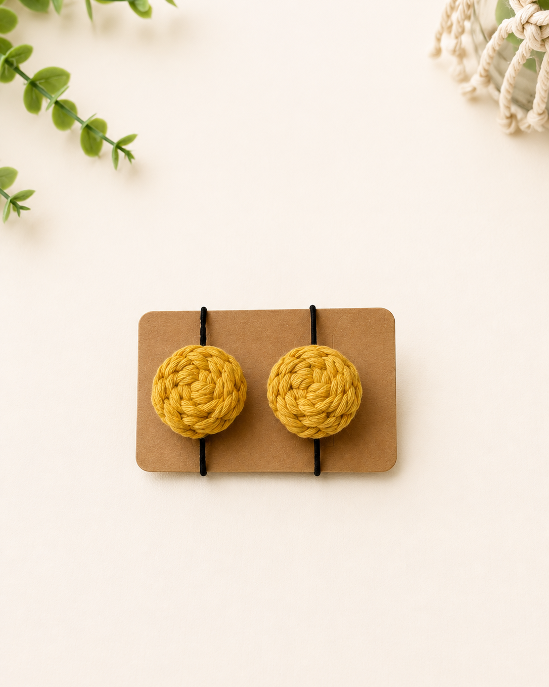 Mustard handmade macrame cotton hair ties with black elastic bands.