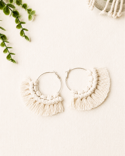 Handmade off white macrame fringe hoop earrings with stainless steel hoops.