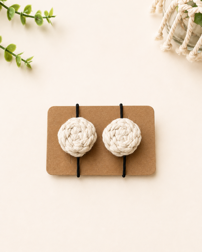 Off white handmade macrame cotton hair ties with black elastic bands.