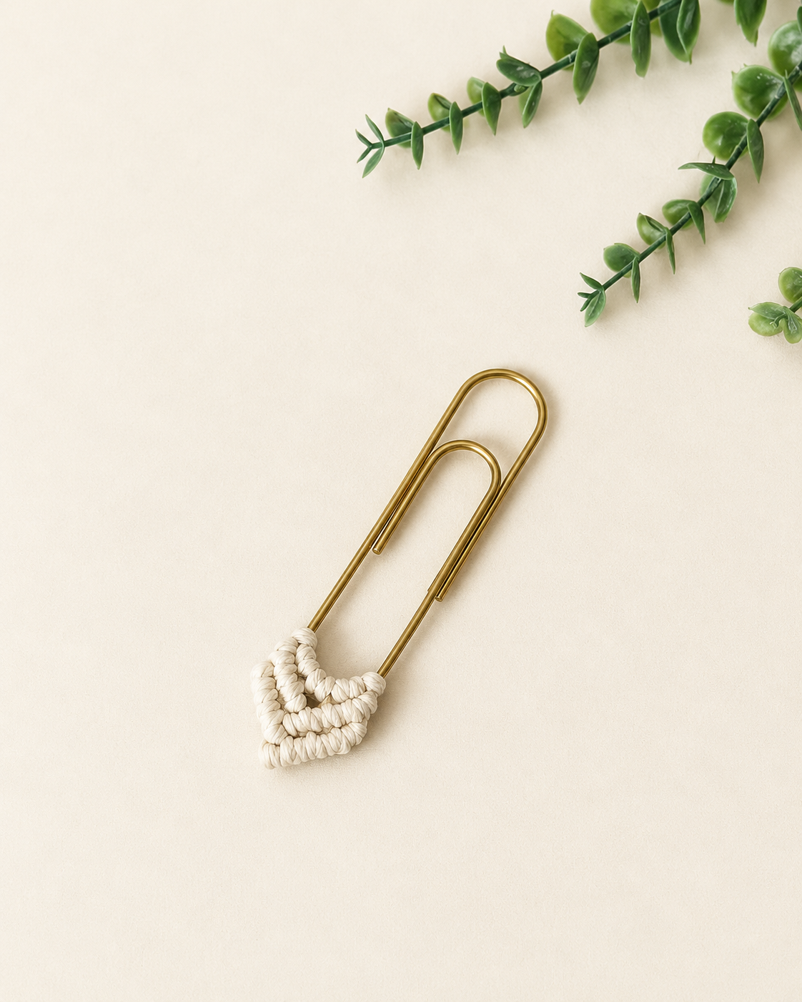 Off-white handmade macrame heart bookmark with gold paper clip