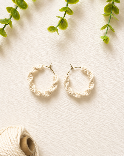 Off-white handmade macramé spiral hoop earrings with lightweight hoop design.