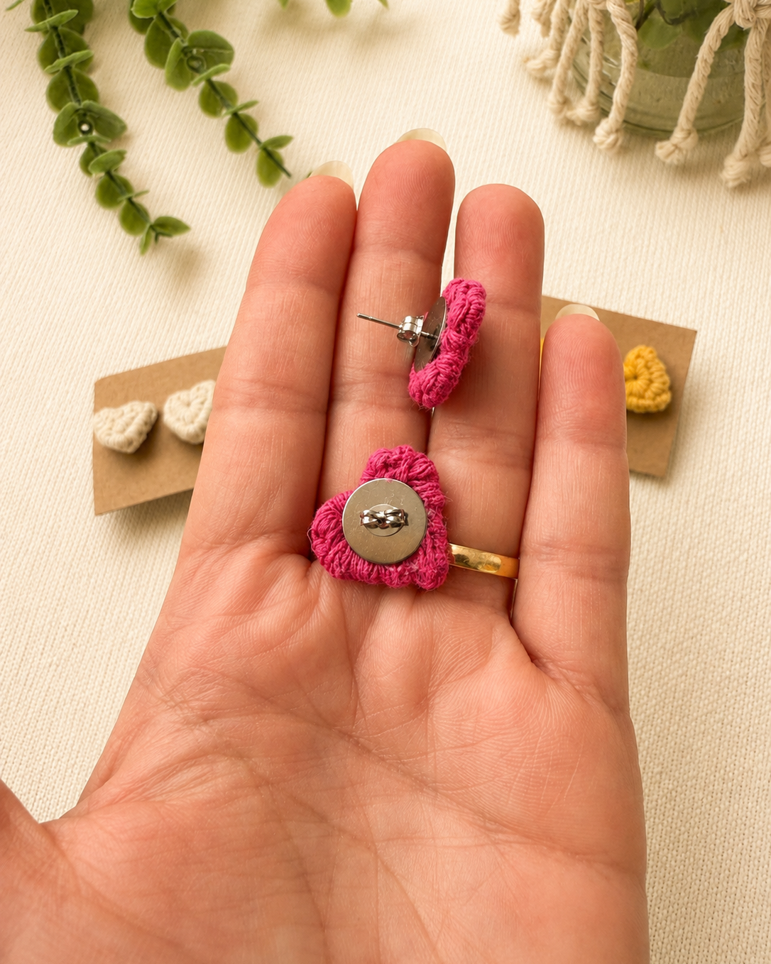 Back view of handmade pink macrame heart stud earrings with stainless steel posts.