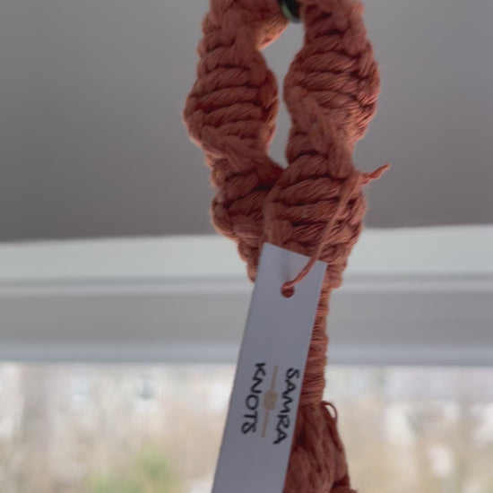 Handmade terracotta macrame plant hanger featuring half hitch knots, styled with an indoor plant and shown from different angles to highlight the knot details and craftsmanship.