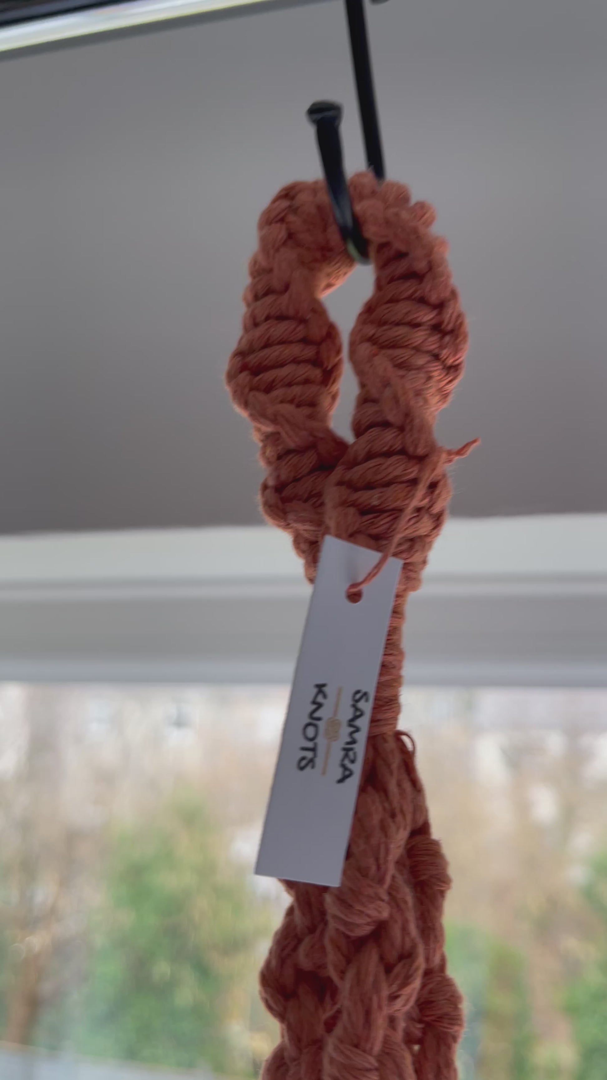 Handmade terracotta macrame plant hanger featuring half hitch knots, styled with an indoor plant and shown from different angles to highlight the knot details and craftsmanship.