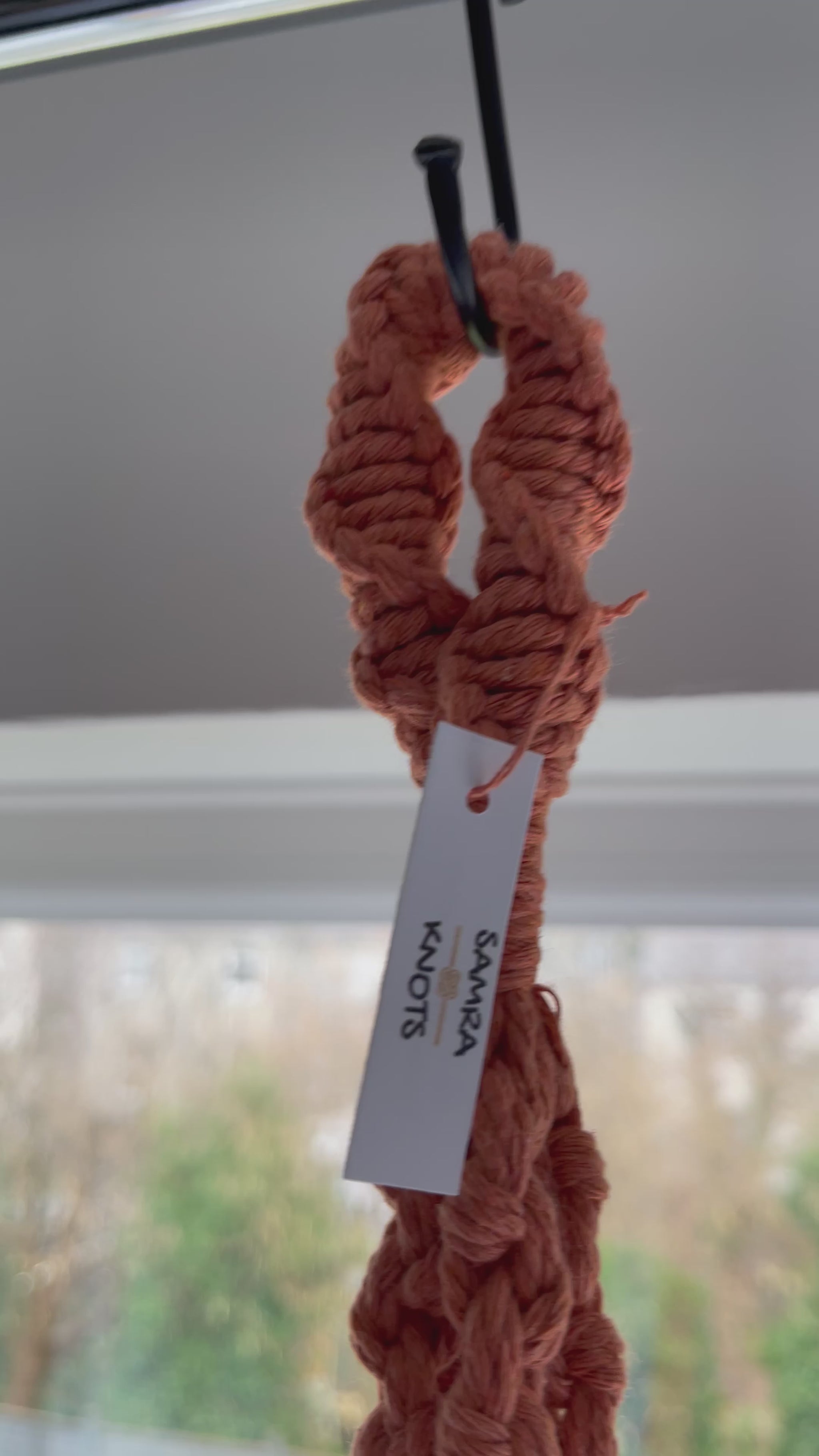 Handmade terracotta macrame plant hanger featuring half hitch knots, styled with an indoor plant and shown from different angles to highlight the knot details and craftsmanship.