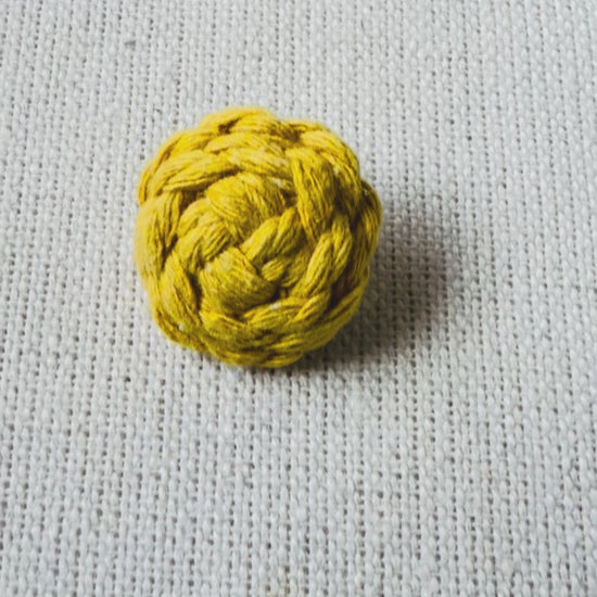 Video showing handmade mustard macrame button brooch from different angles