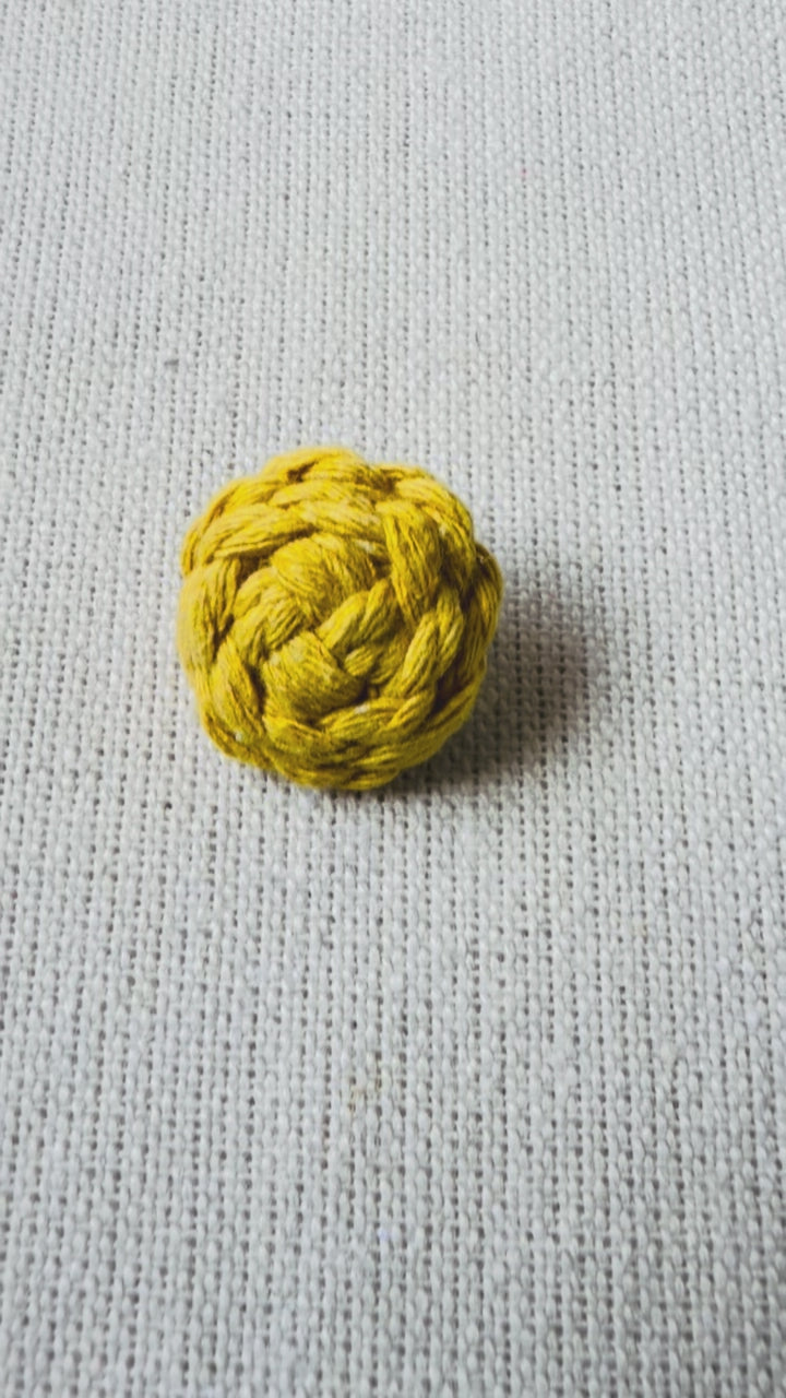 Video showing handmade mustard macrame button brooch from different angles