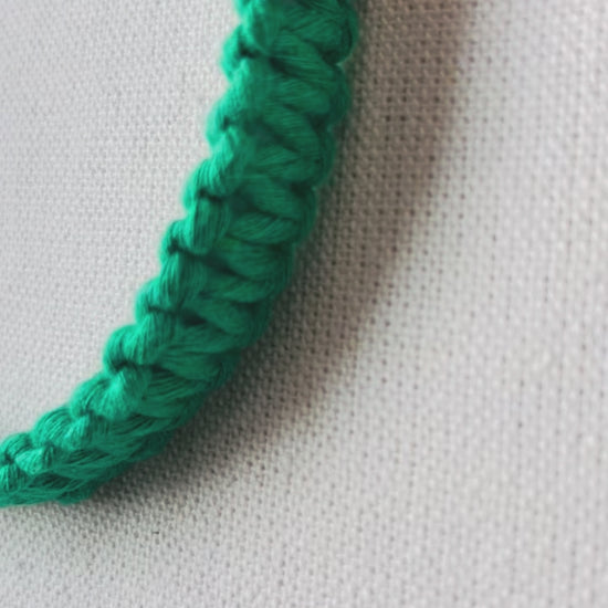 Video showing handmade macrame square knot headbands in multiple colours with close-up views of the textured knot design and comfortable fit.