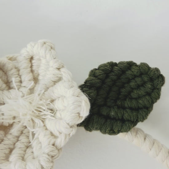 Floral macrame wall hanging showing handmade flower, leaves and cotton knot details