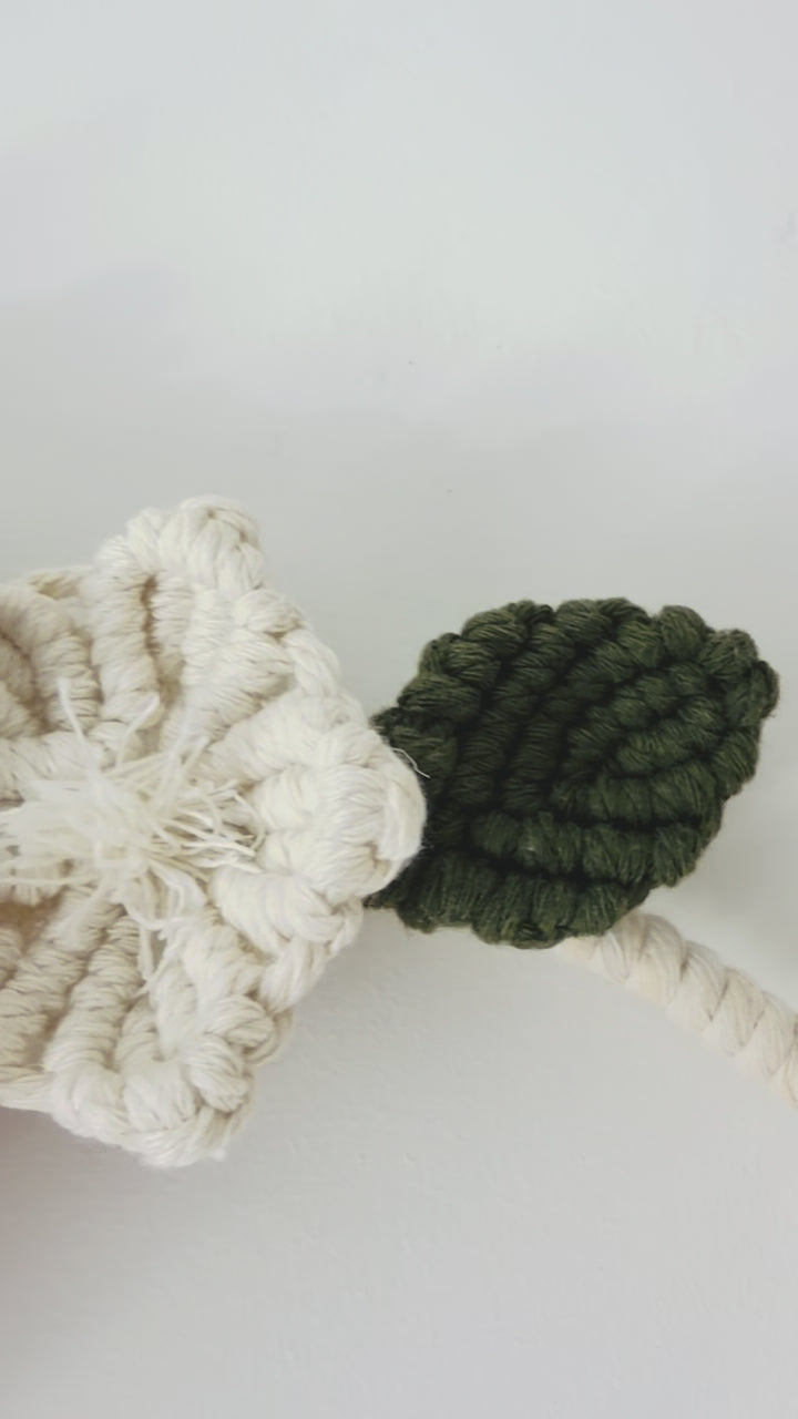 Floral macrame wall hanging showing handmade flower, leaves and cotton knot details