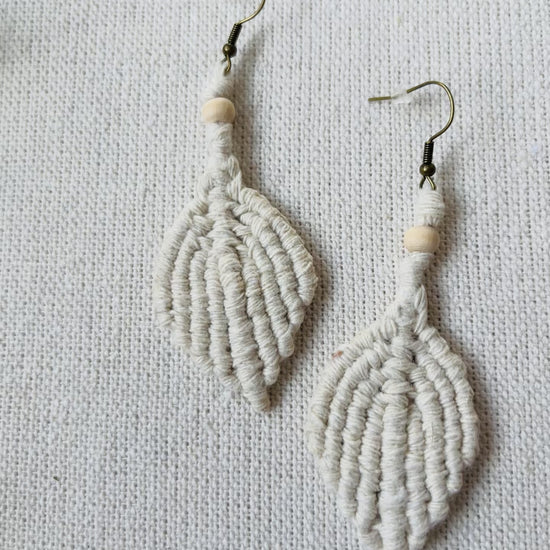Video showing handmade macrame leaf earrings from different angles and close-up details.