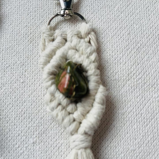 Video showcasing handmade macrame gemstone keychains in five colours with natural gemstones and cotton tassels.
