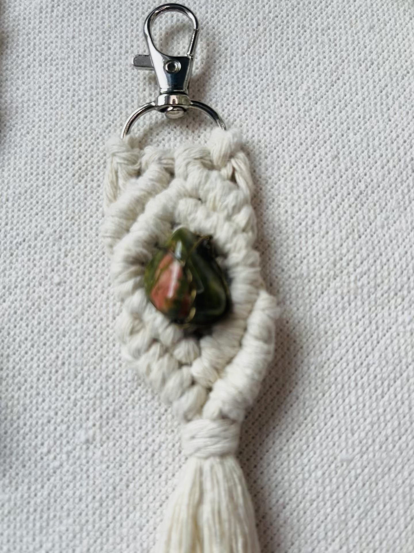 Video showcasing handmade macrame gemstone keychains in five colours with natural gemstones and cotton tassels.