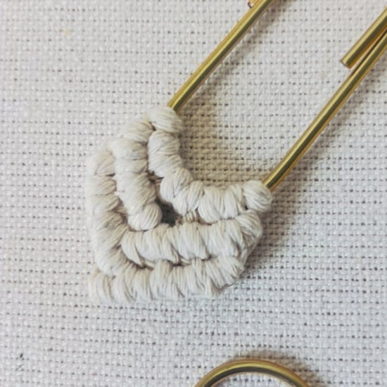 Close-up video showing the handmade knots on a macramé heart bookmark