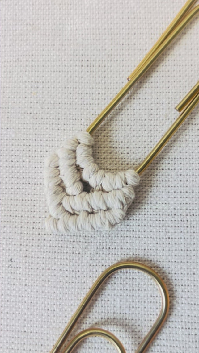 Close-up video showing the handmade knots on a macramé heart bookmark