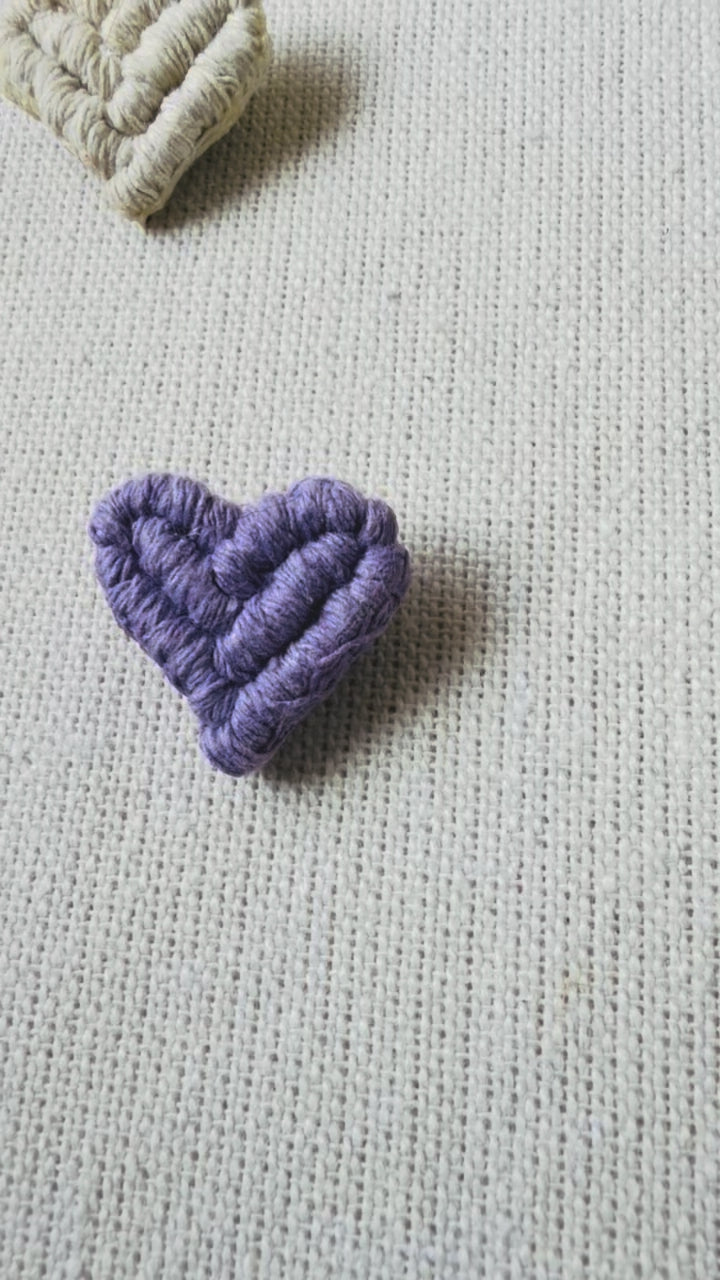Video showing handmade lilac macrame heart brooch from different angles