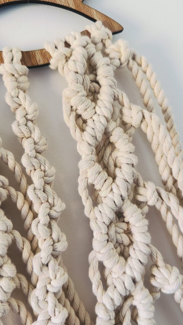 Video showing the handmade lotus macrame wall hanging from different angles, highlighting its detailed knotwork and natural cotton texture.