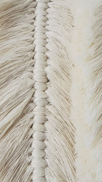 Handmade Egyptian cotton macrame feather wall hanging showing detailed knotting and brushed texture
