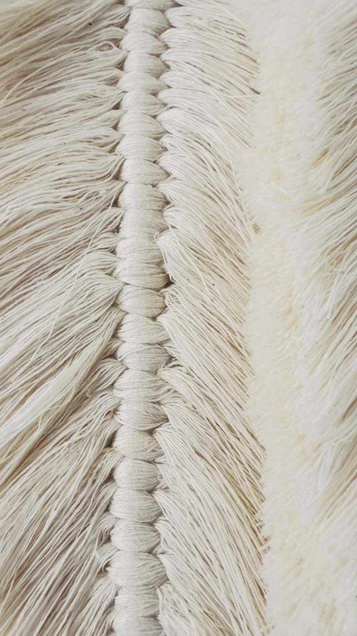 Handmade Egyptian cotton macrame feather wall hanging showing detailed knotting and brushed texture