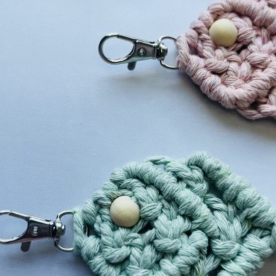 Video showcasing handmade macrame fish keychains in multiple colours, including sage green, terracotta, mustard, blush pink and off white. Boho cotton keychains with coastal-inspired design and metal clasps.