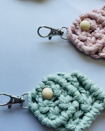 Video showcasing handmade macrame fish keychains in multiple colours, including sage green, terracotta, mustard, blush pink and off white. Boho cotton keychains with coastal-inspired design and metal clasps.