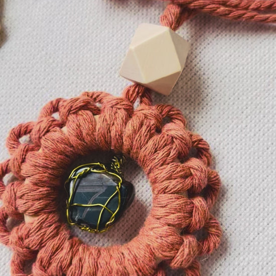 Video showcasing handmade macrame car charms with genuine natural gemstones and unfinished wooden essential oil diffuser beads in five colour options.